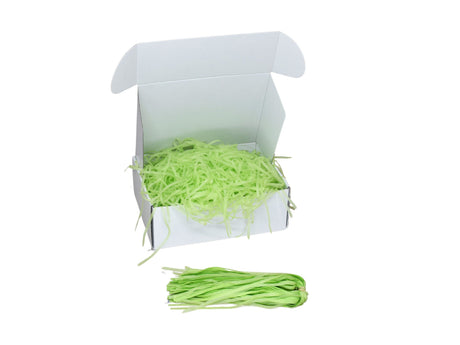 Umplutură din hârtie de mătase verde lime expusă într-o cutie cadou albă